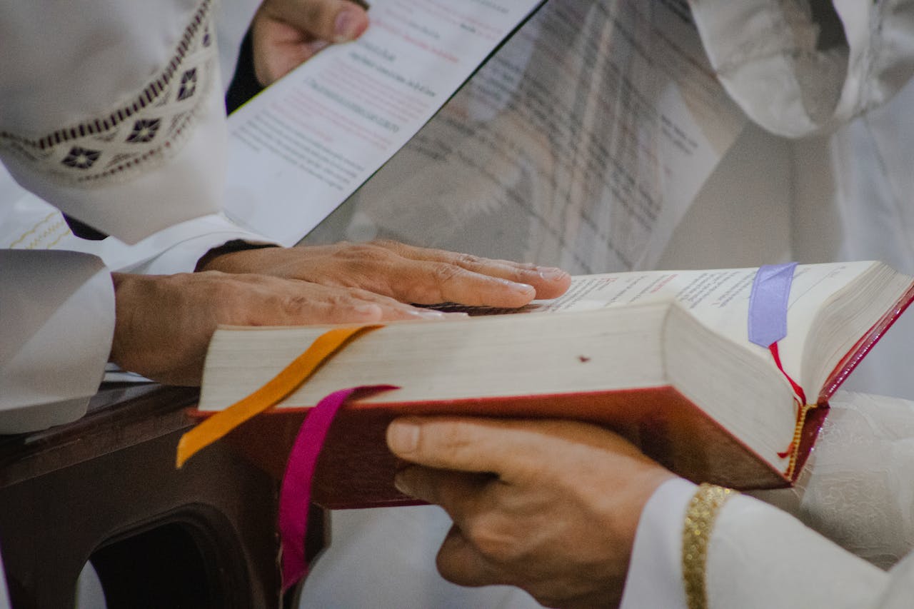 Close-up of People Holding Books during a Religious Ceremony